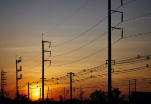 The electric poles and electric lines with a sky of sunset